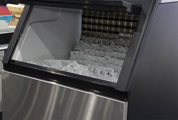 Open bin of a commercial ice machine filled with ice